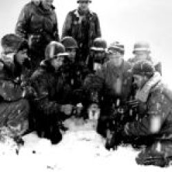 (Illustration Combat Conditions) Engineers of the 111-ECB (36-ID) group around a small blown torch to heat and drink coffee (January 27, 1945, Weitbruch-France)