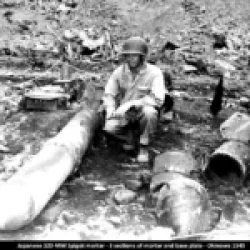 Japanese 320-MM Spigot mortar showing 3 sections of the mortar and the base plate
