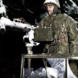 Pvt Charles Preston (Nicholasville Kentucky) brushes snow away from Water Cooled M-1917