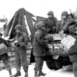 Soldiers of the 4185th Quartermaster Service Company load trucks with rations at Liege in Belgium