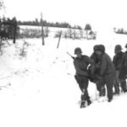 Wounded American soldier is being taking over to the Air Station – January 1945